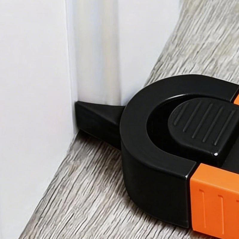 Close view of the pointer touching the foot of a white door casing