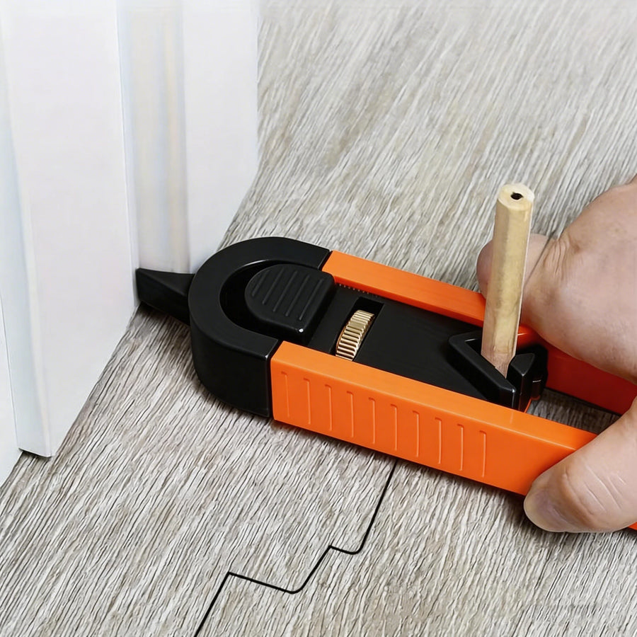 The scribing tool in use on a floor plank: its pointer follows a white door casing while a pencil in the sliding holder draws the same stepped outline on the plank