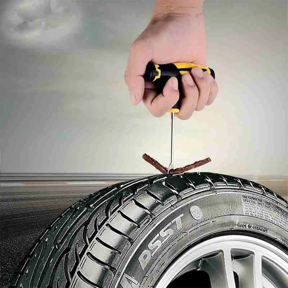 Pushing a rubber strip into a car tire tread with the T-handle inserter