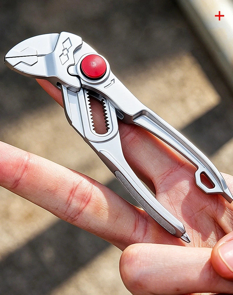 The silver pliers lying across an open palm, showing the textured strip and the tips on the handle ends