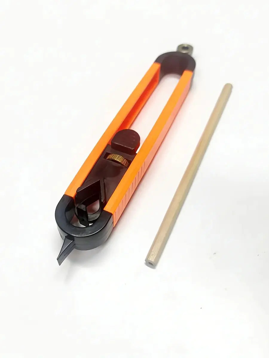 The tool seen from the pointer end in a taller frame, with a wooden pencil beside it