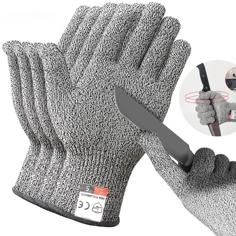 Gray HPPE cut-resistant gloves stacked to show the cut level 5 cuff tag, beside a gloved hand holding a knife blade