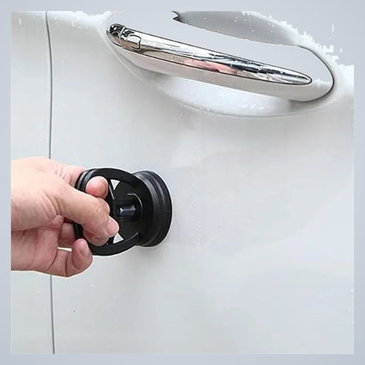 Pulling a shallow dent in a car door beside the handle