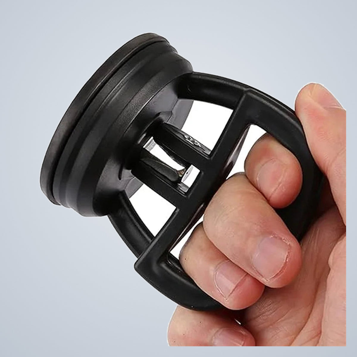 The puller held in one hand, showing the moulded handle cage over the rubber cup