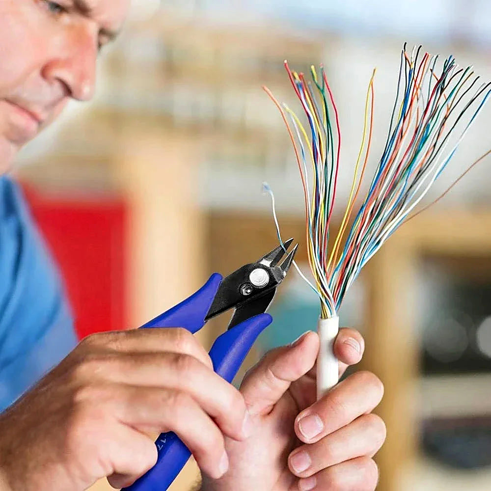 Flush cutters trimming a bundle of fine wires held in one hand