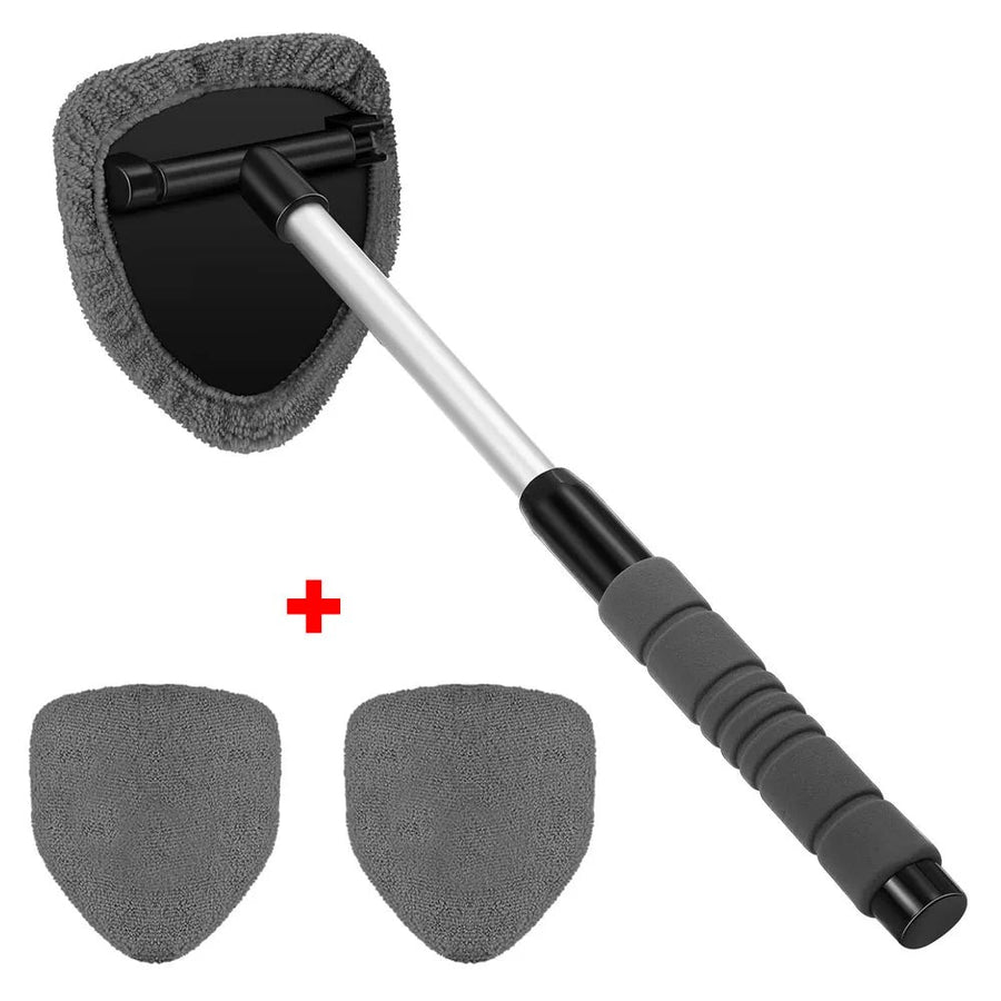 The gray set on white: the triangular head with a pad fitted, and two spare pads beside it