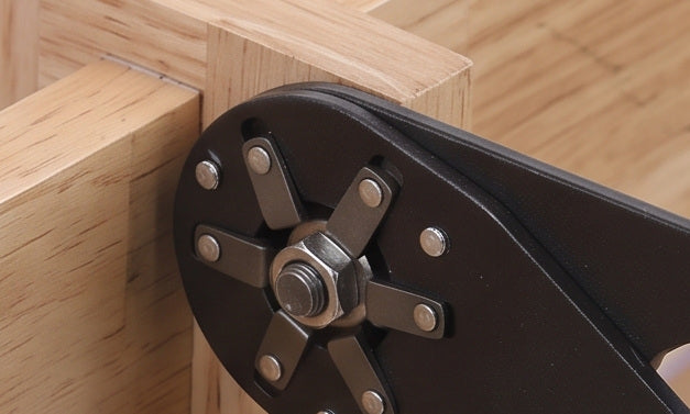 The wrench on a bolt in a timber frame